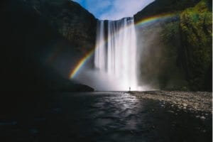 rainbow across waterfall